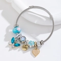 Stainless steel adjustable wire bracelet with blue butterfly and love heart charms - Blue