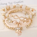 Bohemian 4-piece multilayer beaded bracelet set with infinity charm and crown pendant - White