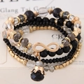 Pulsera de varias capas con símbolo de infinito dorado y colgante de corona negra - Negro