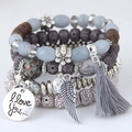 Bohemian multilayer beaded bracelet with cat eye stone wings and tassel pendants - Gray