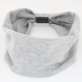 Close-up of grey elastic cotton headband showing knitted texture and fabric label - Light Gray