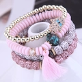 Bracelet multicouche style bohème avec pendentif main de Hamsa et pompons roses - Rose