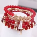 Set bracciali multistrato bohémien in cristallo rosso con ciondolo a nappa dorata - Rosso