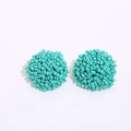 Close-up of handmade turquoise seed bead stud earrings in a cluster dome design - Cyan