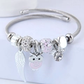 Silver stainless steel spiral bracelet with pink owl and white feather charm detail - Pink