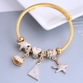 Adjustable golden twisted rope bracelet with nautical charms like starfish and shell - White
