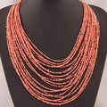 Bohemian multi-layer seed bead necklace in coral pink with gold-tone accents - Pink