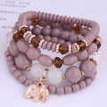 Bohemian multi-layer beaded bracelet set with purple crystals and gold elephant pendant - Coffee