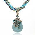 Bohemian long pendant necklace featuring a vintage teardrop turquoise stone and bronze floral cap - Blue