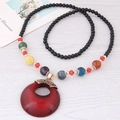 Long collier perlé de style ethnique bohème avec grand pendentif anneau rouge sur bois - Rouge