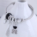Silver steel wire bracelet with black beads, crystal bear and heart charms - Black