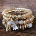 Bohemian multi-layer elastic beaded bracelet set with crystal charms on wood - Coffee