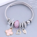 Bracciale argentato con perline, quadrifoglio rosa, corona e ciondoli lettera D - Rosa