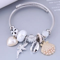 Charming silver beaded bracelet with angel wings heart and ocean shell charms - White