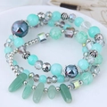 Multilayer bohemian beaded bracelet with mint green cat eye stones and silver pendants - Green
