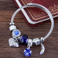 Bohemian adjustable steel bracelet with blue crystal moon and heart charms on wood - Blue