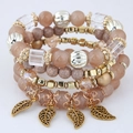 Detailed close-up of pink beaded multi-layer bracelet with gold leaf charms and crystal accents - Coffee