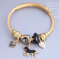 Gold stainless steel wire bracelet featuring pink heart, unicorn, and crystal bead charms - Black