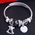 Silver charm bracelet featuring zircon bear, black beads, and Ailan engraved tag charms - Black