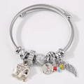 Silver twisted cable charm bracelet featuring elephant and wing pendants with crystals - White