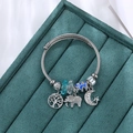 Zilveren staaldraad armband levensboom met blauwe olifant en ster-maan bedeltjes - Blauw