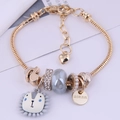 Golden snake chain charm bracelet with pearl beads and a cartoon lion pendant - Gray