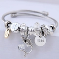 Silver steel wire bracelet with crystal beads and sparkling diamond dolphin pendant - White