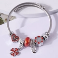 Silver twisted wire charm bracelet with red four-leaf clover and heart pendants - Red