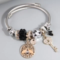 Adjustable stainless steel wire bracelet with bee and key charms in a DIY Pandora style - Black