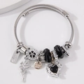 Brazalete de acero inoxidable con colgantes de hada, corazón de cristal y dijes - Negro
