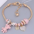 Golden heart bracelet with pink bear charm and zircon beads on a snake chain - Pink