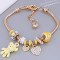 Golden snake chain charm bracelet with matte bear, heart pendant and pearls for women - Yellow