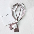 Elegant narrow brown and white vertical striped silk scarf tied in a stylish neck bow - Six Frame Camel