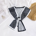 Detail of a black and white geometric silk scarf draped elegantly on a textured background - Black White Geometric Maze (1)