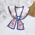 Detail view of floral print silk scarf with blue trim and tied bow on white fabric - Light Pink Blue Floral Cluster (3)