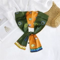 Detail of double-sided printed silk scarf featuring tropical leaves and floral patterns - Dark Green Orange Floral Bottle (6)