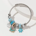 Silver twisted wire bracelet featuring blue elephant, tree of life, and crown charms - Lake Blue