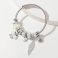 Silver twisted open bangle with butterfly and pearl charms in a minimalist style - White