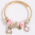 Golden DIY bangle with pink charms, pearl beads, and a sparkling bear pendant charm - Macaron Pink