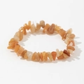 Macro shot of natural orange sunstone elastic bracelet with irregular polished crystal chips - Orange & Beige (Moonstone/Sunstone)