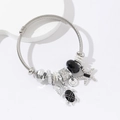 Adjustable stainless steel nautical bangle with starfish, turtle, and shell charms - Black