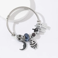 Silver beaded bracelet featuring blue beads, owl charm and crescent moon pendant - Black