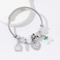Silver woven charm bracelet with pearl heart, cherry pendant, and love charms on white stand - White