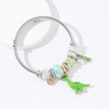 Silver woven rope bracelet featuring a green dinosaur charm and colorful crystal beads - Green