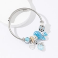 Silver twisted stainless steel bangle with blue charms and Princess pendant tag - Blue