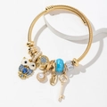 Adjustable gold owl bracelet with blue charms, shell pendant and pearl beads - Blue