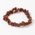 Detailed view of irregular red jasper gemstone elastic bracelet on white background - Red Brown