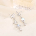 Elegant S925 silver butterfly earrings with moonstone tassels on cream fabric background - Silver (A77)