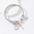 Bracciale a corda intrecciata argento con ciondoli cuore, chiave e corona - Bianco
