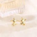 Polished golden reindeer stud earrings in a running pose on soft textured fabric - Gold